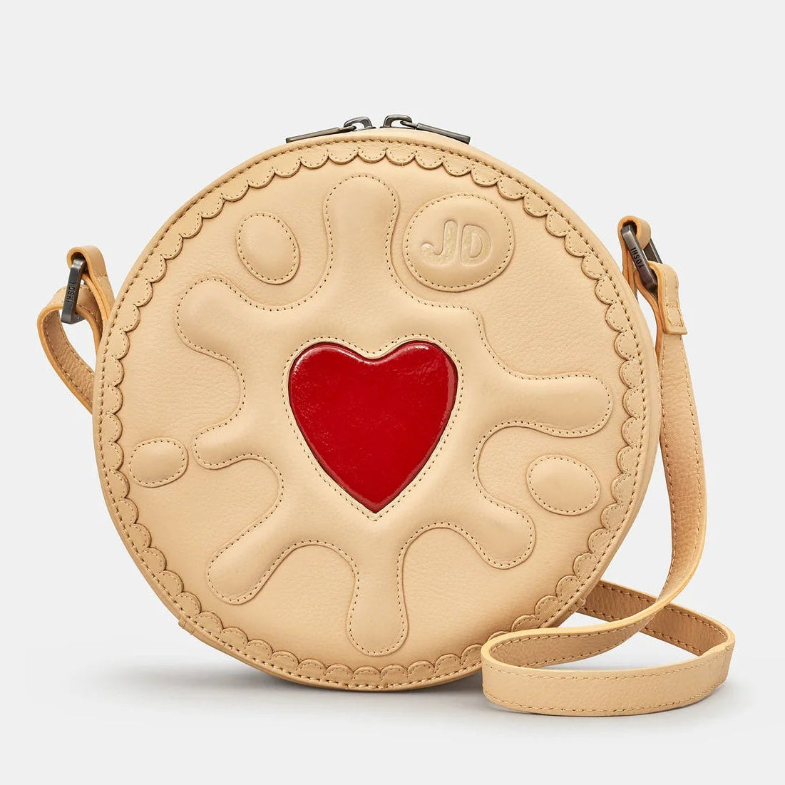 Front view – Jammie Dodger Biscuit Leather Cross Body Bag with cream leather and red heart centre detailing.