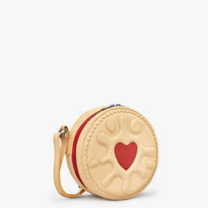 Side angle – Side profile of Jammie Dodger Biscuit Leather Cross Body Bag showing round shape and red heart detail.