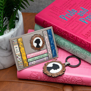 Jane Austen leather card holder and matching keyring styled with hardcover editions of Austen novels and a potted plant.