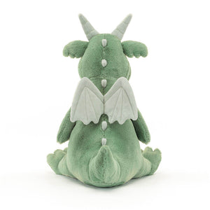 The back of a green dragon plush toy. The toy is sitting down and has a long tail. It is made by Jellycat.