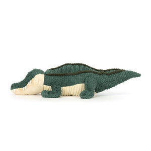 Side profile of Jellycat Allexi Alligator plush toy featuring long tail, chunky legs, corded fabric back, and soft cream belly.