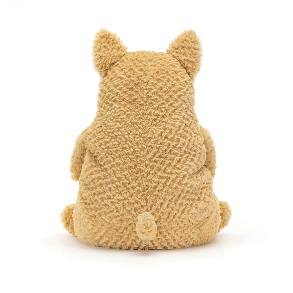 The back of a cream corgi plush toy. The toy is sitting down and has a fluffy tail. The toy is made by Jellycat.