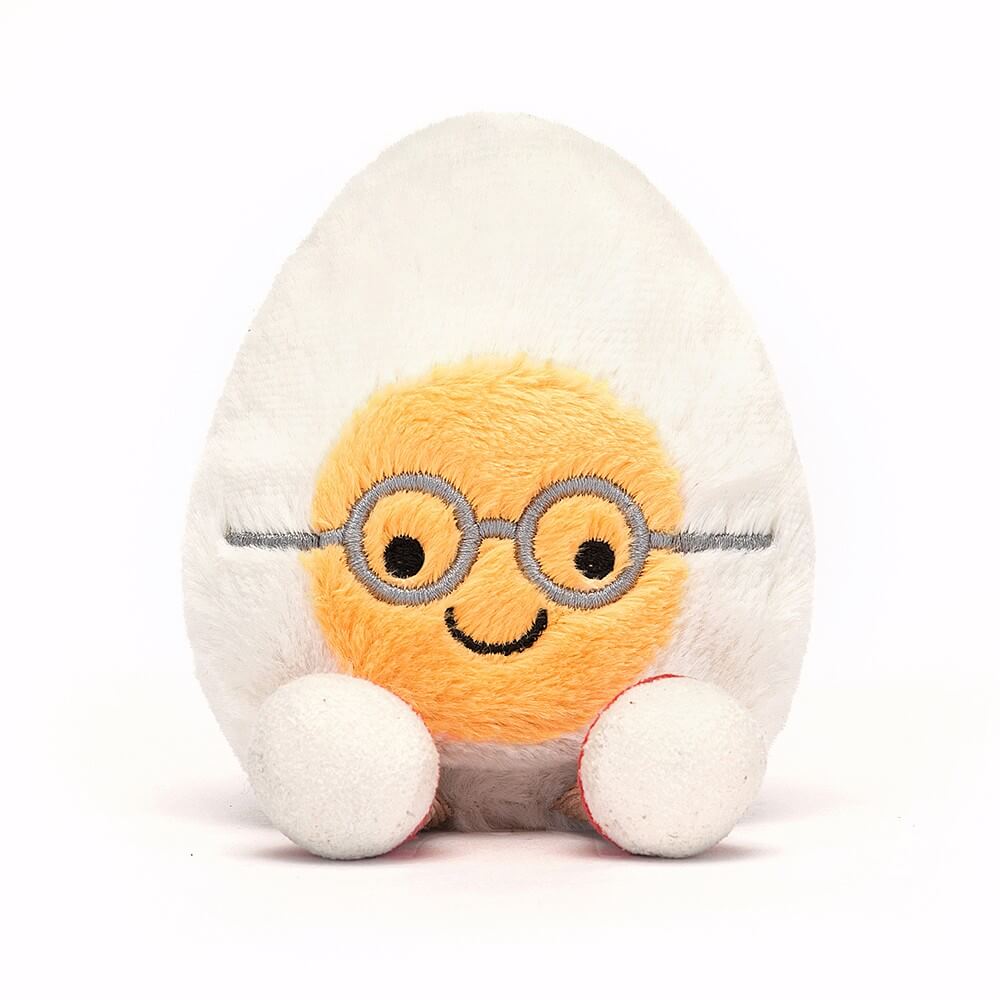 Smiling Jellycat Boiled Egg Geek plush, wearing glasses and red trainers, ready for an egg-cellent adventure.
