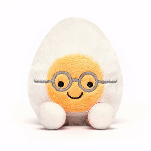 Smiling Jellycat Boiled Egg Geek plush, wearing glasses and red trainers, ready for an egg-cellent adventure.
