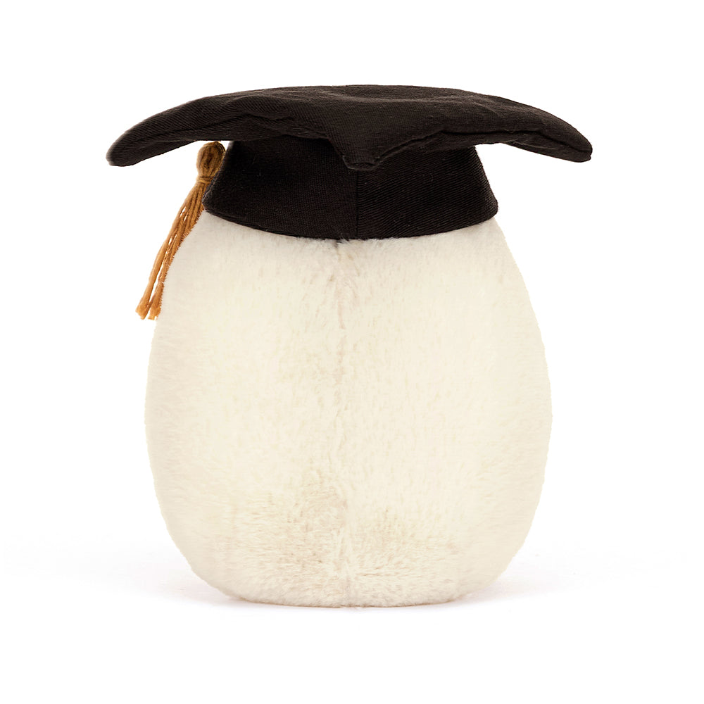 Side View: It's graduation day! The Jellycat Boiled Egg Graduation Plush is decked out in a cap, gown, and diploma.