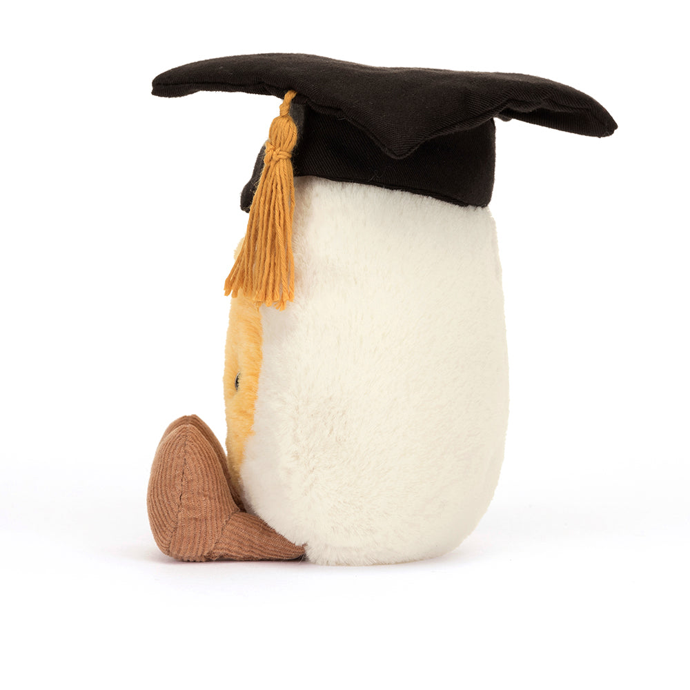 Back View: Way to go graduate! The Jellycat Boiled Egg Graduation Plush in a cap and gown, a unique gift for a special day.