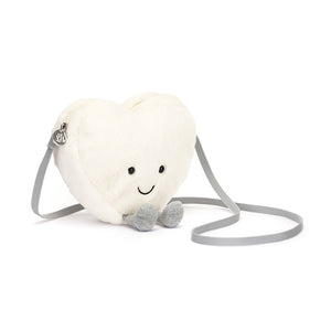 Angled View: Sugar and spice and everything nice! The Jellycat Cream Heart Bag is a delightful plush purse, perfect for carrying essentials with a touch of whimsy.