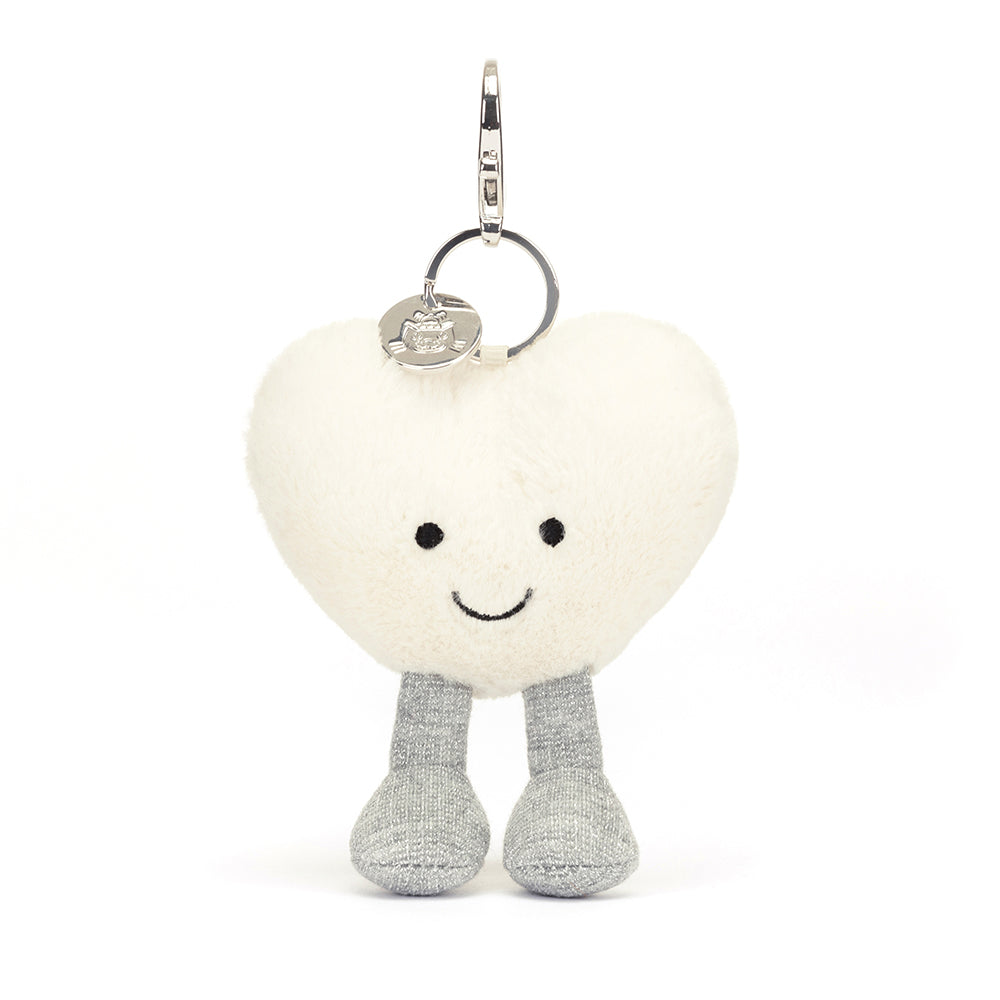 Front View: Spread love on the go! The Jellycat Cream Heart Bag Charm, a soft plush heart with a secure clasp for attaching to bags.
