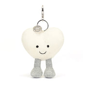 Front View: Spread love on the go! The Jellycat Cream Heart Bag Charm, a soft plush heart with a secure clasp for attaching to bags.