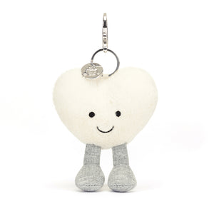 Front View: Spread love on the go! The Jellycat Cream Heart Bag Charm, a soft plush heart with a secure clasp for attaching to bags.