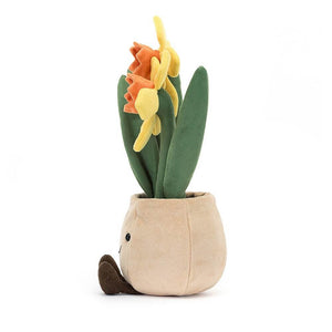 Side view of the whimsical Jellycat Amuseable Daffodil Pot. Crafted from luxuriously soft fabric, this pot is filled with "furry soil" and boasts long green leaves and three cheerful daffodils. A perfect addition to any room for a touch of springtime magic.