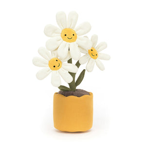 Jellycat Amuseable Daisy sits in a yellow linen pot, with brown soil. There are three flowers with cream suedette petals and each flower has a smiling face.