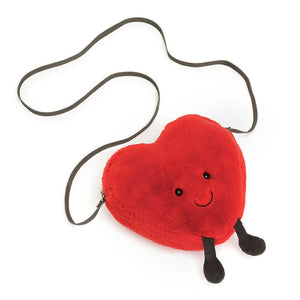 A Jellycat Amuseables Heart Bag lying flat, showing its dimensions and details, such as the heart shape and soft materials.