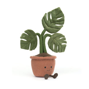 A playful Monstera houseplant plush toy sits at an angle, showcasing its corduroy boots, stitched leaves, and endearing smile. Perfect for plant lovers of all ages!