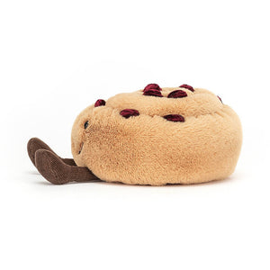 From the side the Jellycat Amuseable Pain Au Raisin with little legs sticking out in front.