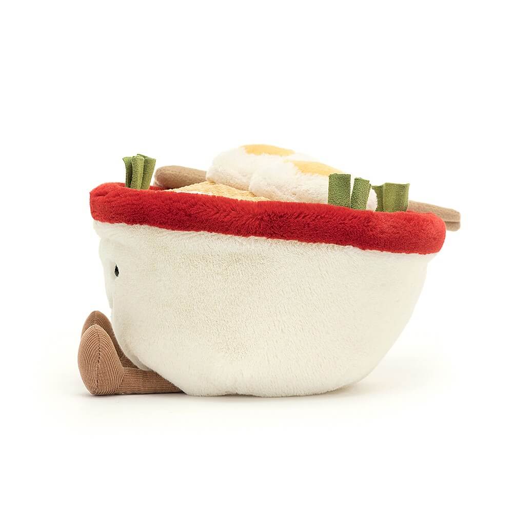 Peek inside the yummy details! The Amuseable Ramen boasts fluffy eggs, suedette spring onions & a pink fish cake nestled in wavy cord noodles, all within a charming red & cream bowl.