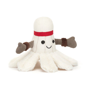 Jellycat Amuseable Sports Badminton plush toy, resembles a badminton shuttlecock with soft cream fur, red headband, brown corded arms, and a feathery fluffy cream skirt.