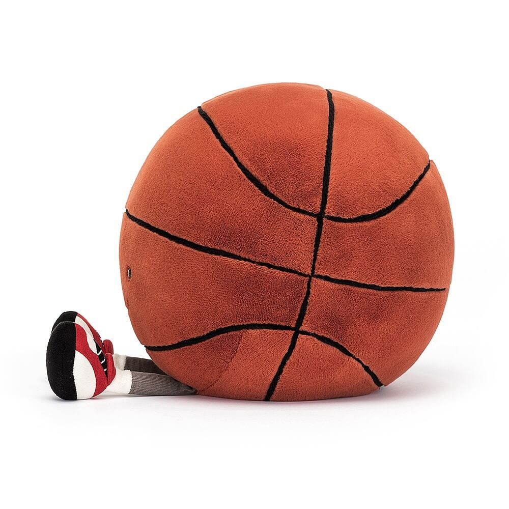 Jellycat Amuseable Sports Basketball children's soft toy from the side with little legs sticking out in front.