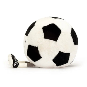 From the side, legs stretched out in front the Jellycat Amuseable Sports Football children's soft toy.