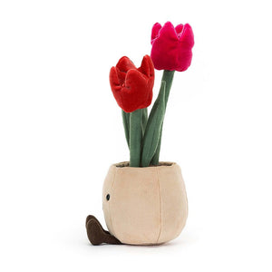 A playful side view of the Jellycat Amuseable Tulip Pot, highlighting its full height of 30cm and 11cm width, showcasing the vibrant tulips, soft leaves, and charming felt pot with its unique fudge cord boots.
