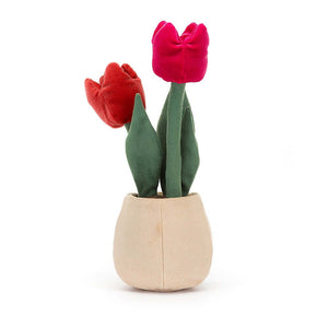 A whimsical view of the Jellycat Amuseable Tulip Pot from behind, revealing its soft suedette leaves and the intricate details of the hot pink and cherry red textured tulips, adding a touch of playful surprise.