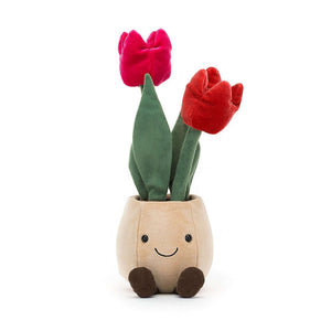 A delightful Jellycat Amuseable Tulip Pot, bursting with colorful, textured tulips in hot pink and cherry red, sitting proudly in its beige felt pot with its fuzzy suedette leaves and cute fudge cord boots.