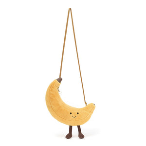 Jellycat Amuseables Banana Bag plush toy, showcasing its mustard strap and suedey mocha tip.