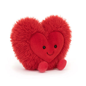 Angled View: Jellycat Amuseables Beatie Heart plush toy, soft and cuddly, red heart with a mischievous grin.