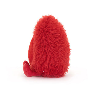 Side View: Jellycat Amuseables Beatie Heart from the side showing soft red fur and corded red boots.