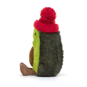 Side View: A side view of a cuddly avocado toy, showcasing its three-dimensional shape and the bobble on its head.