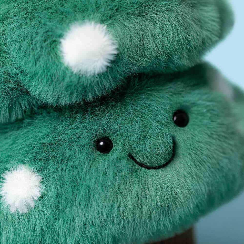 Close-up of Jellycat Christmas Tree showing soft green fur and white pom-pom details.