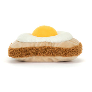 Back view of Jellycat Amuseables Egglantine Egg on Toast showing the textured golden-brown toast base and the soft, rounded design of the plush egg.