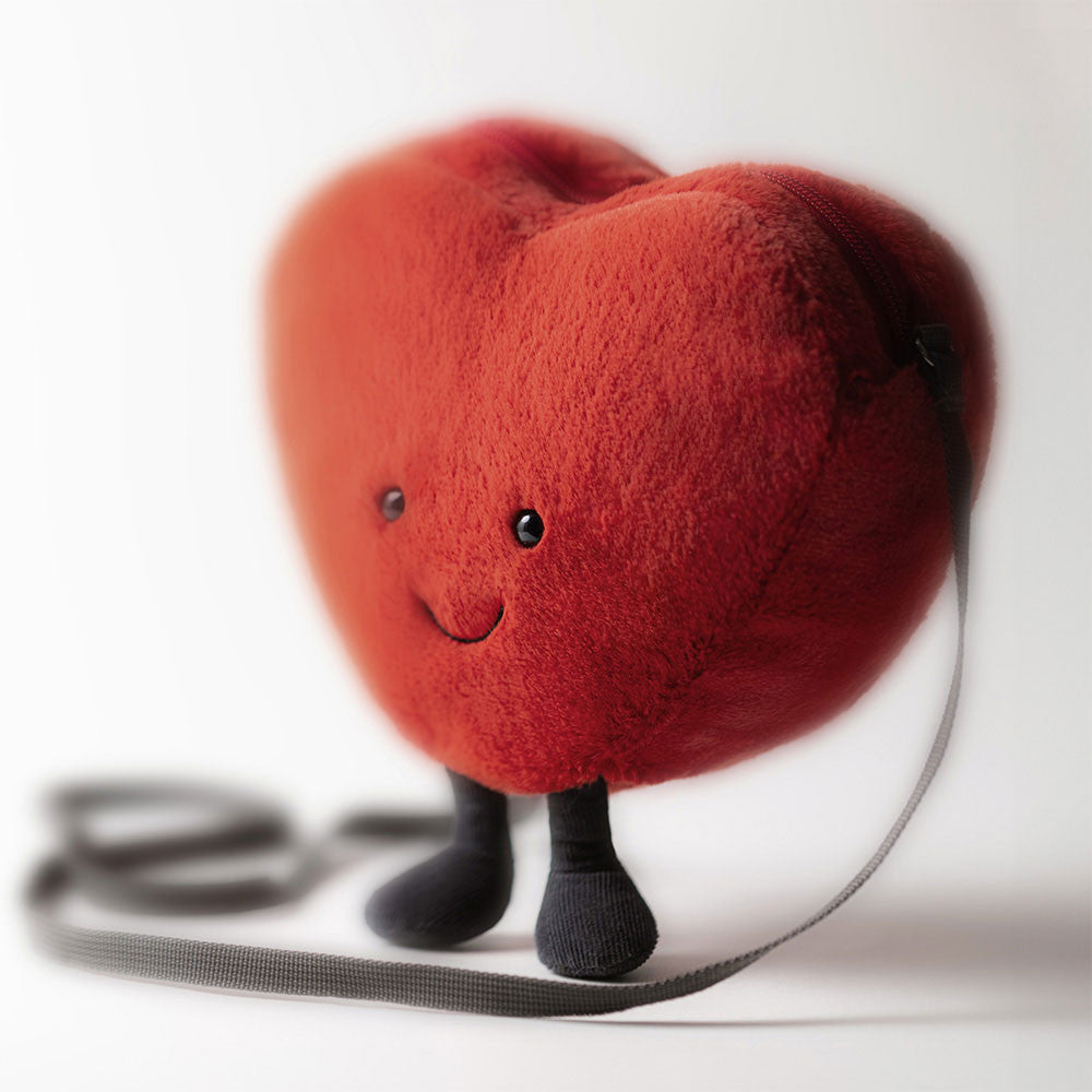 Close-up of the Jellycat Heart Bag showing its soft texture and embroidered smile.