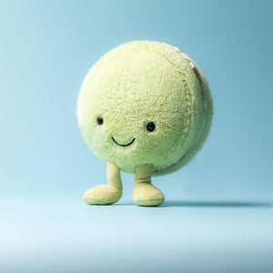 A pastel green Jellycat Amuseables Max Macaron plush toy with a smiling embroidered face and soft textures.