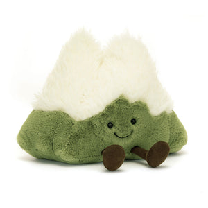 Angled View: Cozy adventures await! The Jellycat Amuseable Mountain sits tilted, showcasing its lush green fur with a peak of curly cream "snow." Earthy cord boots add a playful touch. Perfect for imaginative playtime! 