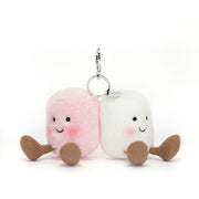 Straight On View: Front view of the adorable Jellycat Marshmallow Bag Charm. Features two soft,( one pink & one white ) plush marshmallows with embroidered smiley faces, rosy cheeks, and a secure silver claw clip for easy attachment to your bag. A delightful addition for any marshmallow lover!