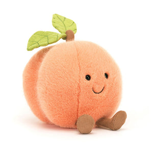 Angled View: A peachy keen cuddle buddy! The Jellycat Amuseables Peach sits tilted, showcasing its gorgeously soft pink fur, funky toffee stalk, green suedey leaf, and embroidered details. 