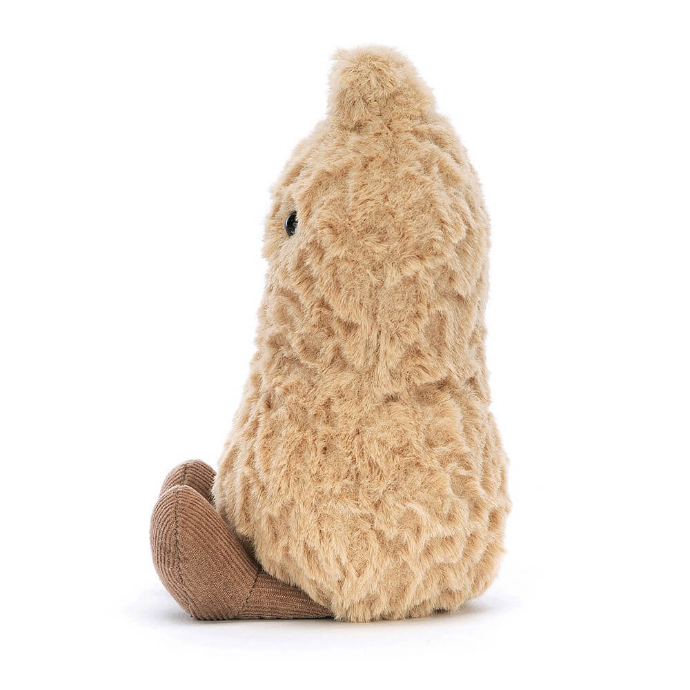 From the side the Jellycat Amuseables Peanut children's soft toy with legs sticking out in front.