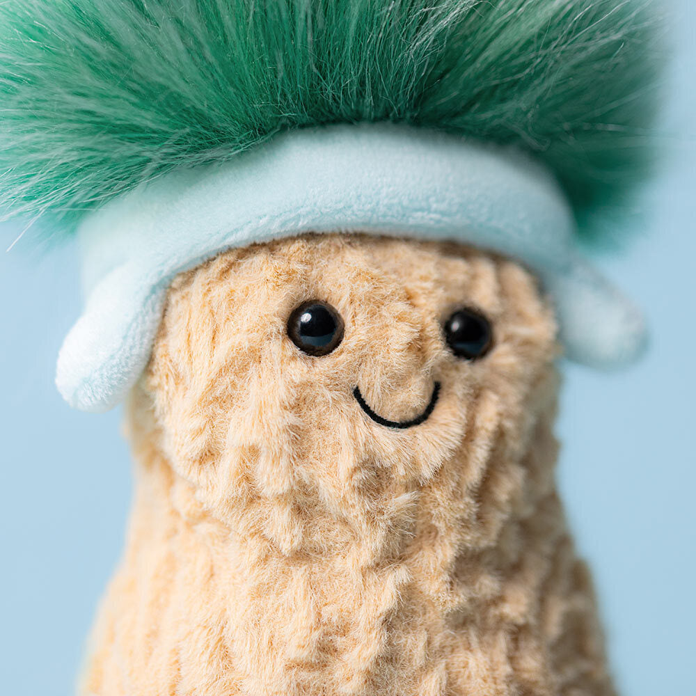 Close-up of Jellycat Amuseables Peanut Après Ski showing smiling face and soft textured body.