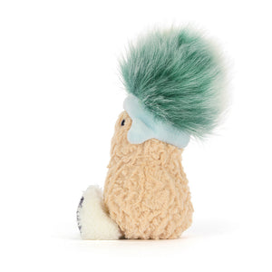 Side view of Jellycat Amuseables Peanut Après Ski soft toy wearing a blue hat with green faux-fur tuft.
