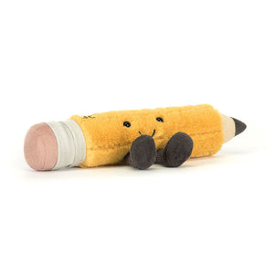 Soft plush Jellycat Amuseables Pencil toy with yellow fluffy body, embroidered smiley face, and black corduroy legs, shown lying on a white background