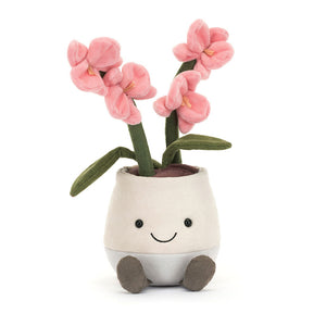 Front view of the Jellycat Amuseables Pink Orchid plush, highlighting its cheerful stitched smile and the details of its soft, suedette leaves.