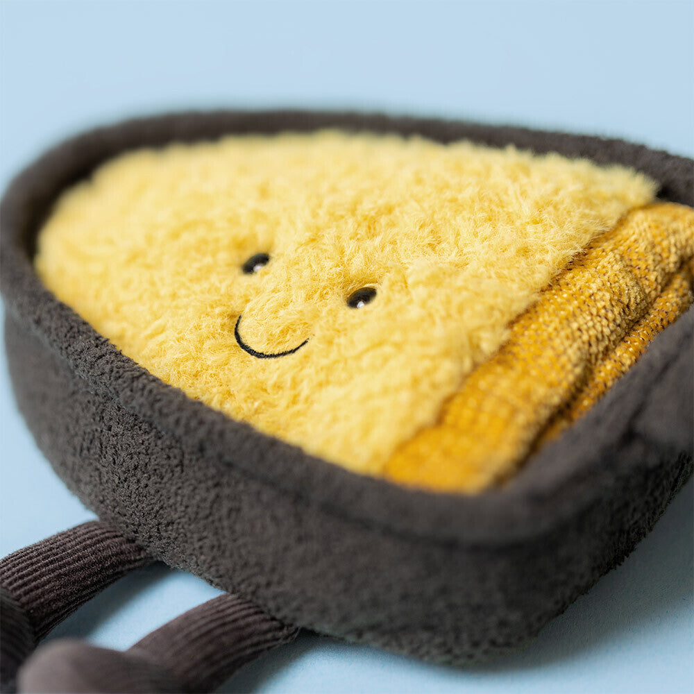 Close-up of Jellycat Amuseables Raclette showing soft yellow cheese texture and embroidered smile.