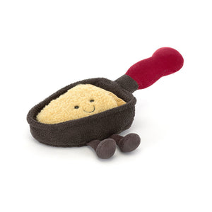 Jellycat Amuseables Raclette plush toy featuring a smiling cheese slice in a dark pan with red handle.