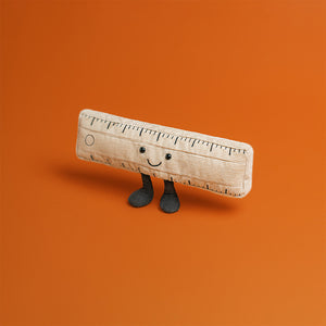 Jellycat Amuseables Ruler toy standing on orange background
