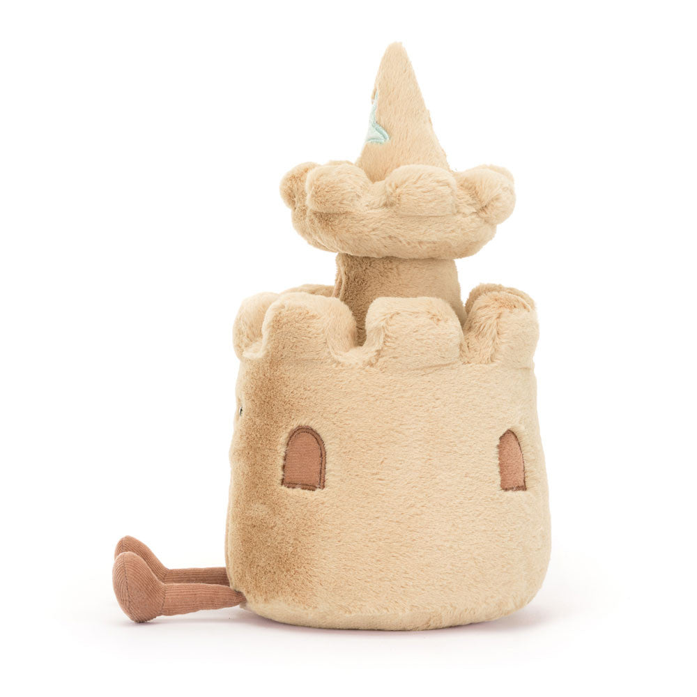 Side view of Jellycat Amuseables Sandcastle showing plush turrets and embroidered window details.