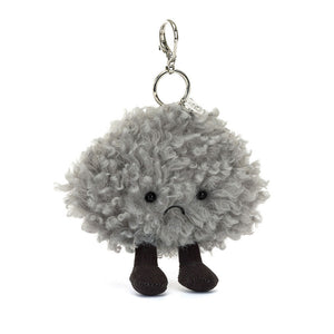 Jellycat Amuseables Storm Cloud Bag Charm, displayed at a slight angle, showcasing its textured grey fur and stitched frown. 