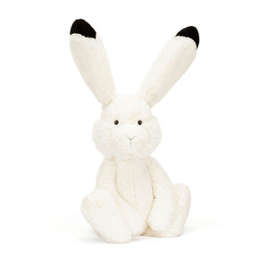 Product slightly to an angle: Jellycat Arlo Hare plush toy in profile, showing his long ears and chunky paws.