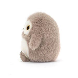 A side view of a Jellycat Barn Owling plush toy, highlighting its floppy wings, textured "mussed truffle" fur, and tiny suedette feet.