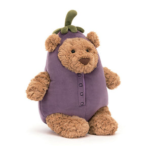 Angled View: Looking dapper in aubergine! The Jellycat Bartholomew Bear Aubergine leans in, showcasing his soft toffee fur peeking through a purple suedette veggie costume with stitched details. Fuzzy green stalk hat with floppy ears completes the playful disguise. Perfect for veggie-loving little ones!